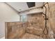 Custom tiled shower includes dual shower heads, neutral decor, and a built-in bench at 100 Hobo Rd, Rotonda West, FL 33947