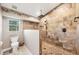 Custom tiled shower includes dual shower heads, neutral decor, and a window for natural light at 100 Hobo Rd, Rotonda West, FL 33947