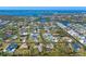 Aerial view of a charming waterfront community with well-maintained homes, lush landscaping, and serene waterways at 1087 Bay Harbor Dr, Englewood, FL 34224