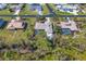 An aerial shot showing the home's screened pool, landscaping and street view, providing a sense of community at 1087 Bay Harbor Dr, Englewood, FL 34224