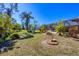 Expansive backyard featuring lush greenery, a charming bird bath, and a screened-in lanai for outdoor enjoyment at 1087 Bay Harbor Dr, Englewood, FL 34224