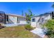 View of the backyard featuring a shed and a small patio with a bench, surrounded by lush greenery at 1087 Bay Harbor Dr, Englewood, FL 34224