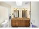 Bright bathroom featuring a double vanity with granite counters and framed mirrors at 1087 Bay Harbor Dr, Englewood, FL 34224