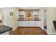 Dining area features custom cabinets, a stone accent wall, and wood flooring at 1087 Bay Harbor Dr, Englewood, FL 34224