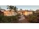 Charming single-story home featuring an attached garage, lush landscaping, and beautiful entryway at 1087 Bay Harbor Dr, Englewood, FL 34224