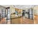 Well-equipped kitchen with stainless steel appliances, granite counters, tile backsplash, and wood floors at 1087 Bay Harbor Dr, Englewood, FL 34224