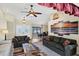 Open living area with vaulted ceilings, fan, and views to the dining room and front entrance at 1087 Bay Harbor Dr, Englewood, FL 34224