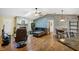 Open living room featuring a stone fireplace, skylight, and stylish wood-look accent wall at 1087 Bay Harbor Dr, Englewood, FL 34224