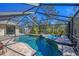 Sparkling pool with screened enclosure and mature trees at 1087 Bay Harbor Dr, Englewood, FL 34224