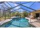 Stunning screened pool and spa surrounded by a private, tropical landscape at 1087 Bay Harbor Dr, Englewood, FL 34224
