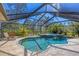 Inviting screened pool and spa area with lush tropical foliage at 1087 Bay Harbor Dr, Englewood, FL 34224