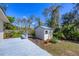 Backyard featuring a shed, a bench, and lush landscaping at 1087 Bay Harbor Dr, Englewood, FL 34224