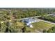Aerial view of home with screened pool, shed, and lush green surroundings at 13354 Blytheville Ave, Port Charlotte, FL 33981