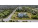 Aerial view of home with screened pool and lush green surroundings at 13354 Blytheville Ave, Port Charlotte, FL 33981
