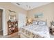Comfortable bedroom featuring a queen bed, bookshelf, and beach themed decorations at 13354 Blytheville Ave, Port Charlotte, FL 33981