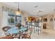 Cozy dining area with glass table, wicker chairs, and views of the pool at 13354 Blytheville Ave, Port Charlotte, FL 33981