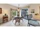 Bright breakfast nook featuring a glass top table and chairs near sliding glass doors at 13354 Blytheville Ave, Port Charlotte, FL 33981