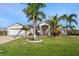 Charming single-Gathering home with a beautiful front lawn and tropical landscaping at 13354 Blytheville Ave, Port Charlotte, FL 33981