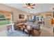 Open-concept living room with large sectional couch and views to the lanai at 13354 Blytheville Ave, Port Charlotte, FL 33981