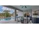Relaxing screened-in pool area featuring an in-ground pool, patio furniture, and ceiling fan at 13354 Blytheville Ave, Port Charlotte, FL 33981
