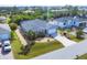 Aerial view of a single Gathering home featuring a well-manicured lawn and tasteful landscaping at 15081 Aldama Cir, Port Charlotte, FL 33981