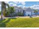 Well-manicured lawn and tasteful landscaping leading up to a single Gathering home at 15081 Aldama Cir, Port Charlotte, FL 33981