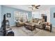 Bright living room featuring tile floors, neutral furniture and an open floor plan at 15081 Aldama Cir, Port Charlotte, FL 33981