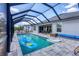 Spacious screened-in pool featuring ample lounge space and an outdoor dining area at 15081 Aldama Cir, Port Charlotte, FL 33981