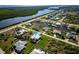 Waterfront home with lush landscaping, screened pool, and canal access at 15691 Meacham Cir, Port Charlotte, FL 33981
