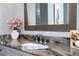 Elegant bathroom vanity featuring a granite countertop, modern faucet, and decorative accents at 15691 Meacham Cir, Port Charlotte, FL 33981