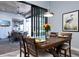 Dining room with wood table, modern chairs, and sliding glass doors to an outdoor space at 15691 Meacham Cir, Port Charlotte, FL 33981