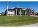 Well-maintained home has manicured front lawn, impact windows, metal roof and three-car garage at 15691 Meacham Cir, Port Charlotte, FL 33981