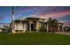 Stunning home with stone accents, lush lawn, and meticulous landscaping at 15691 Meacham Cir, Port Charlotte, FL 33981