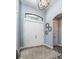 Light and bright foyer with modern lighting and hardwood floors adds to the home's charm at 15691 Meacham Cir, Port Charlotte, FL 33981
