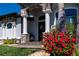 Inviting front porch with stone accents and blooming flowers adds to the home's curb appeal at 15691 Meacham Cir, Port Charlotte, FL 33981