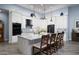 Bright kitchen with white cabinets, pendant lighting, black appliances, and a marble island with seating at 15691 Meacham Cir, Port Charlotte, FL 33981
