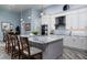 Modern kitchen boasts gray and white cabinets, a large marble island, stainless steel appliances, and pendant lighting at 15691 Meacham Cir, Port Charlotte, FL 33981