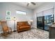 Comfortable sitting room featuring a leather sofa, rocking chair and outdoor view at 15691 Meacham Cir, Port Charlotte, FL 33981