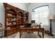 Well-lit office with custom built-ins and a large window creates an ideal workspace at 15691 Meacham Cir, Port Charlotte, FL 33981