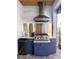 Outdoor kitchen with stainless steel grill, mini fridge, granite countertops, and blue cabinets at 15691 Meacham Cir, Port Charlotte, FL 33981