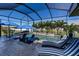 Inviting screened-in pool with water features, lounge chairs, and patio furniture at 15691 Meacham Cir, Port Charlotte, FL 33981