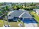 Aerial view of the home showcasing well-maintained landscaping, and a private driveway, close to the canal at 17280 Pheasant Cir, Port Charlotte, FL 33948