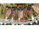 Aerial view of a charming home featuring a red-tile roof, a well-maintained lawn, and a brick driveway at 209 Malina Ct, Nokomis, FL 34275