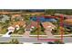 Aerial view of a charming home, manicured yard, and a peaceful lake view in a friendly neighborhood at 209 Malina Ct, Nokomis, FL 34275