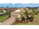 Lovely single Gathering home with terra cotta roof, a two car garage, and a brick paver driveway, with lake views at 209 Malina Ct, Nokomis, FL 34275