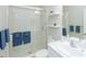 Bright bathroom with a glass-enclosed shower and open shelving at 209 Malina Ct, Nokomis, FL 34275