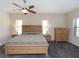 Bedroom with a ceiling fan and a large bed, with ample natural light from windows at 209 Malina Ct, Nokomis, FL 34275
