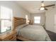 Bright bedroom features natural light, ceiling fan, and wood furniture at 209 Malina Ct, Nokomis, FL 34275