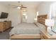 Comfortable bedroom with a ceiling fan, TV, and wooden furniture at 209 Malina Ct, Nokomis, FL 34275
