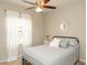 Bedroom showcasing a metal bed frame, neutral tones, and a ceiling fan at 209 Malina Ct, Nokomis, FL 34275
